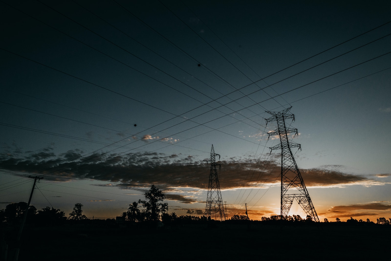 low-angle photography of transmission towers during golden hour